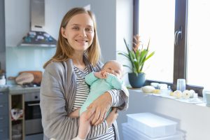 A new mother rocking her baby while embracing the changes of the fourth trimester